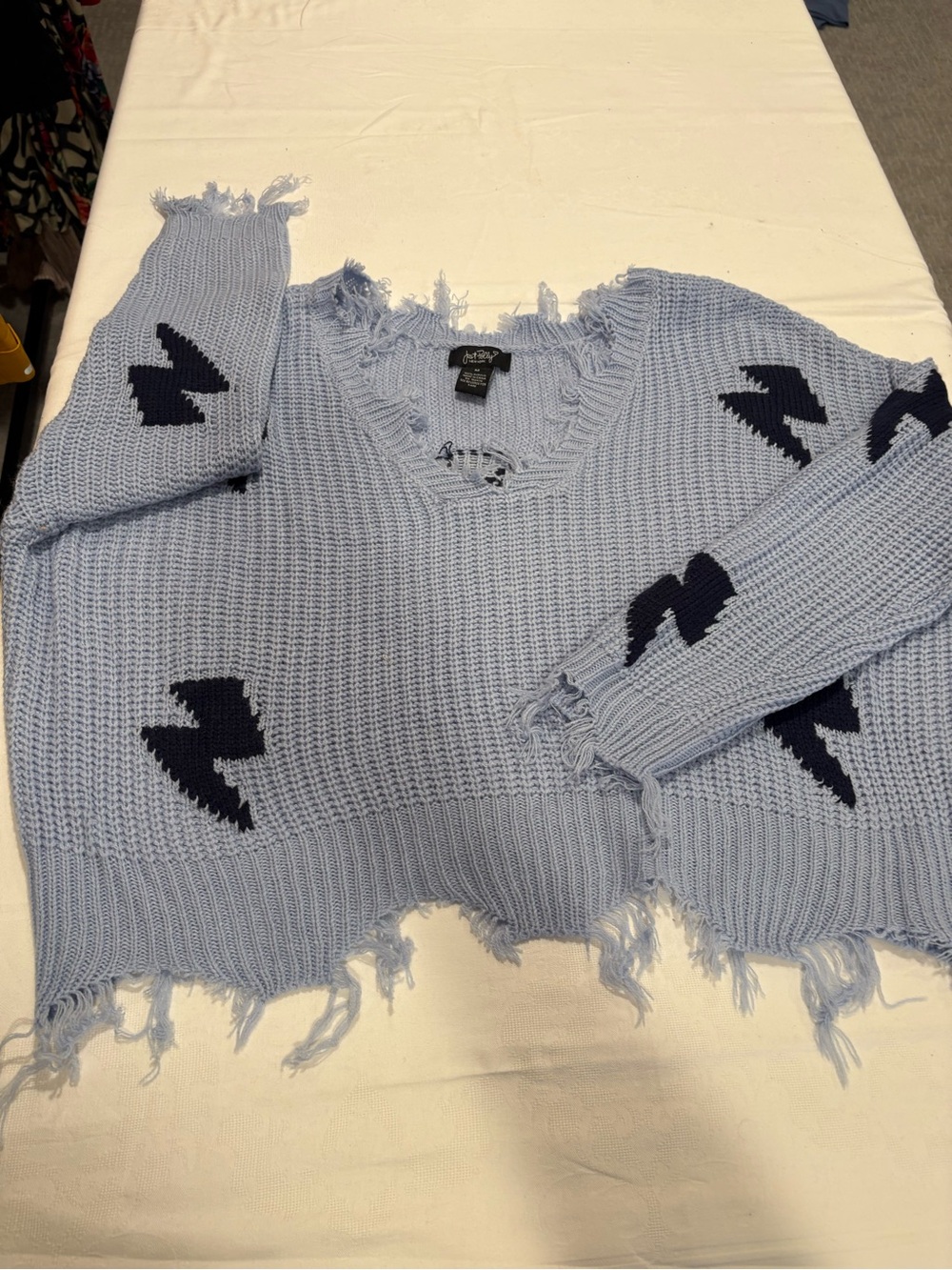 Unwritten Light Blue Distressed V-Neck Sweater with Navy Bolt Motifs